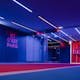 Spacious PSG entrance hallway in Paris with striking neon lighting and club branding.